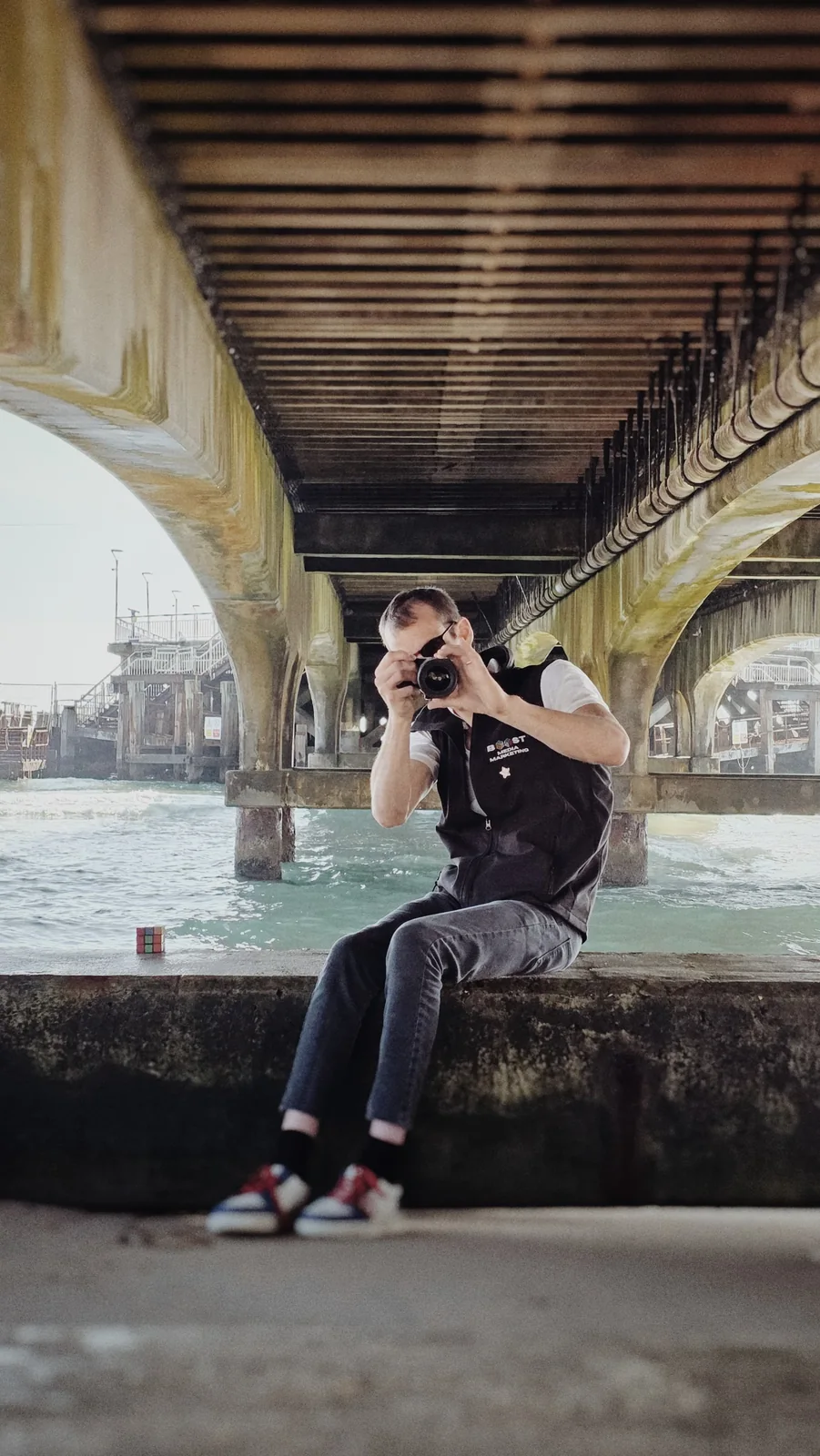 Christian Hacking photographing beneath a pier — Bromley Photography, Chislehurst